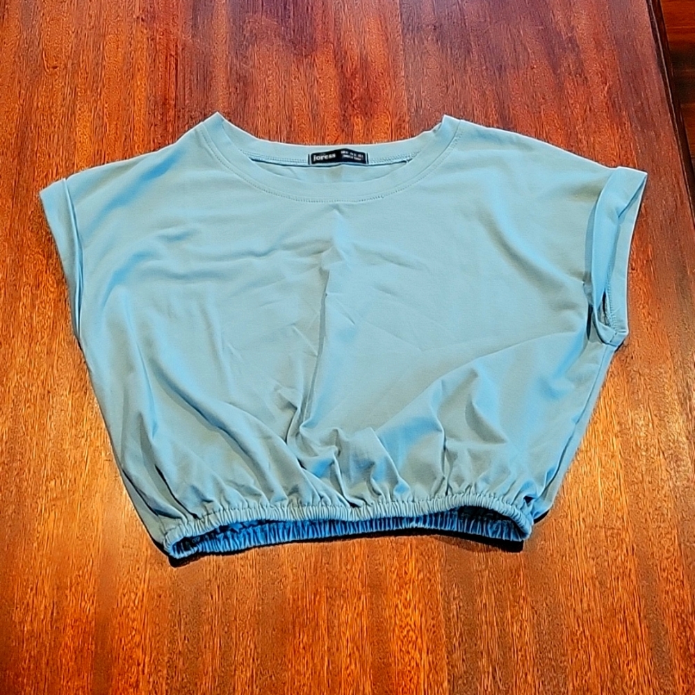 Womens/Juniors size M, tealish colored, cropped with elastic stomach band top.